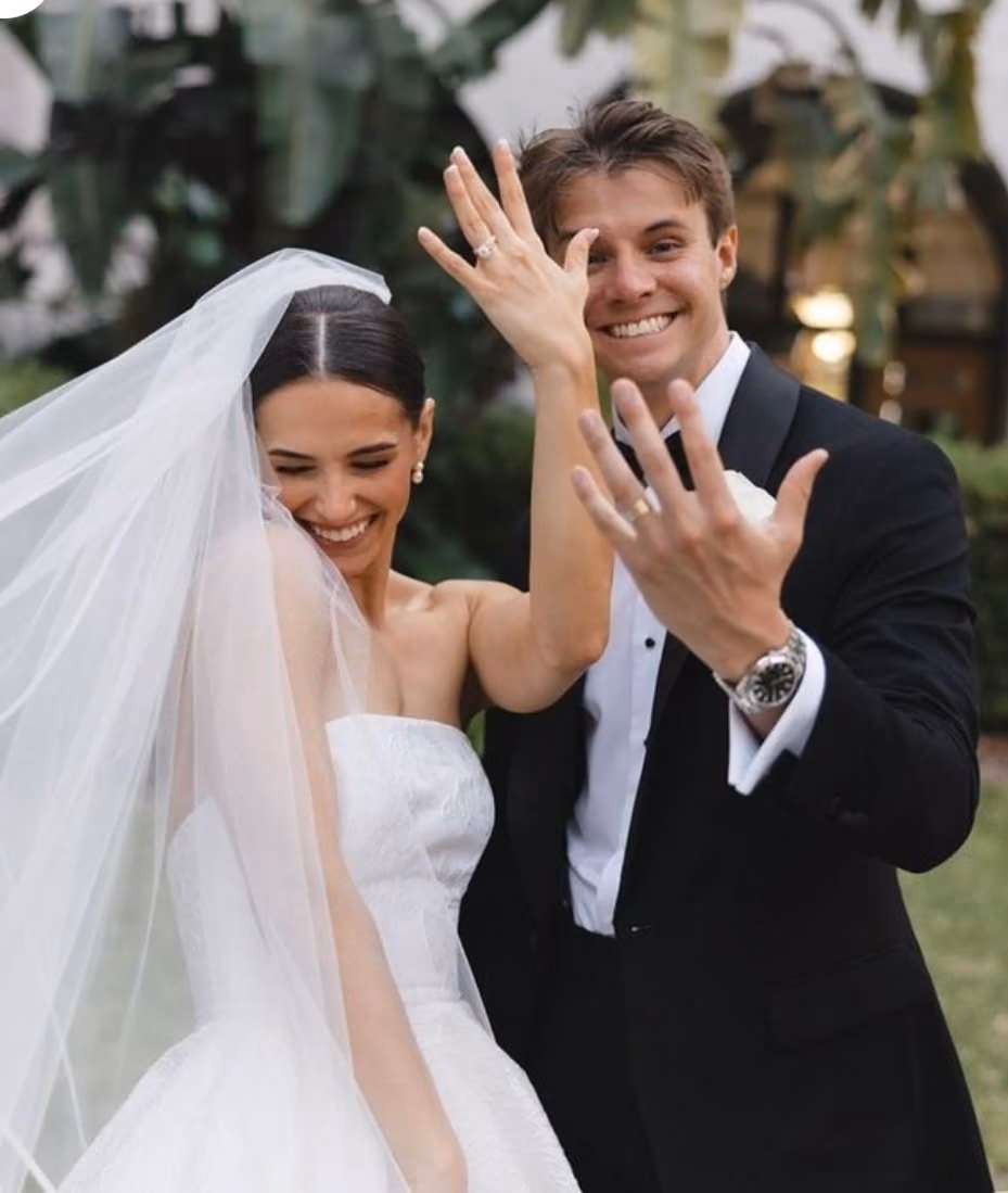 Bride and groom showing their wedding rings
