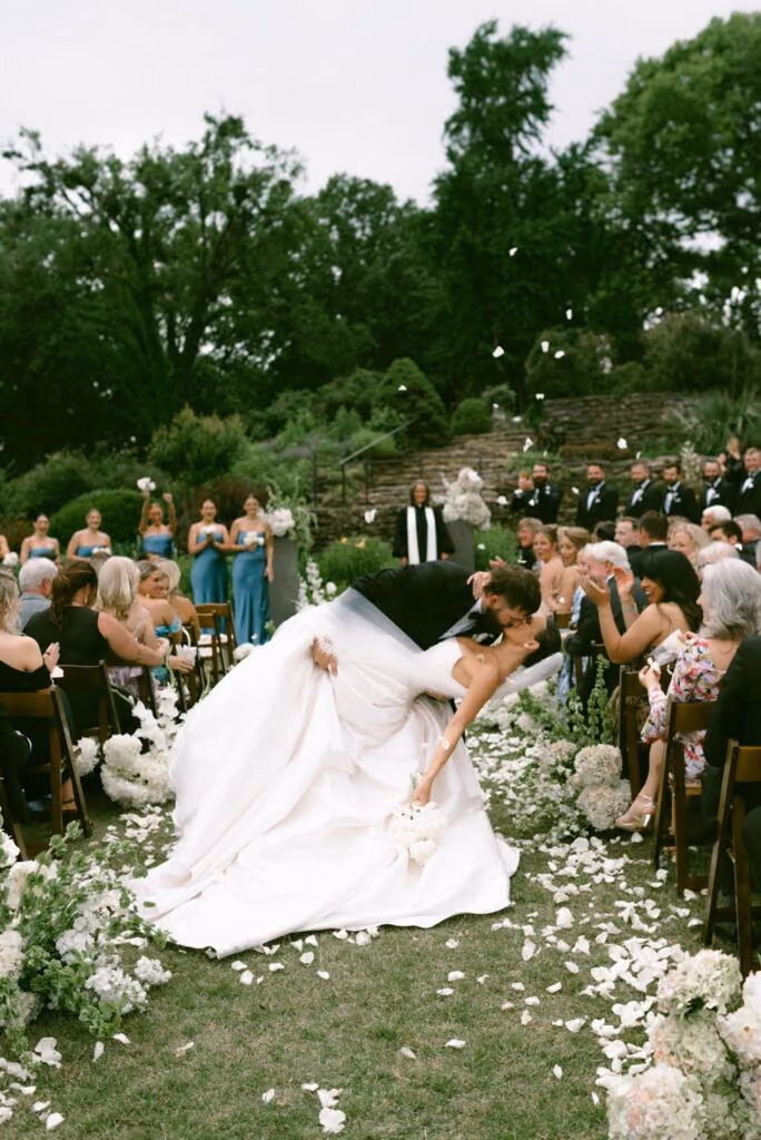 Groom dipping the bride for a kiss at the ceremony